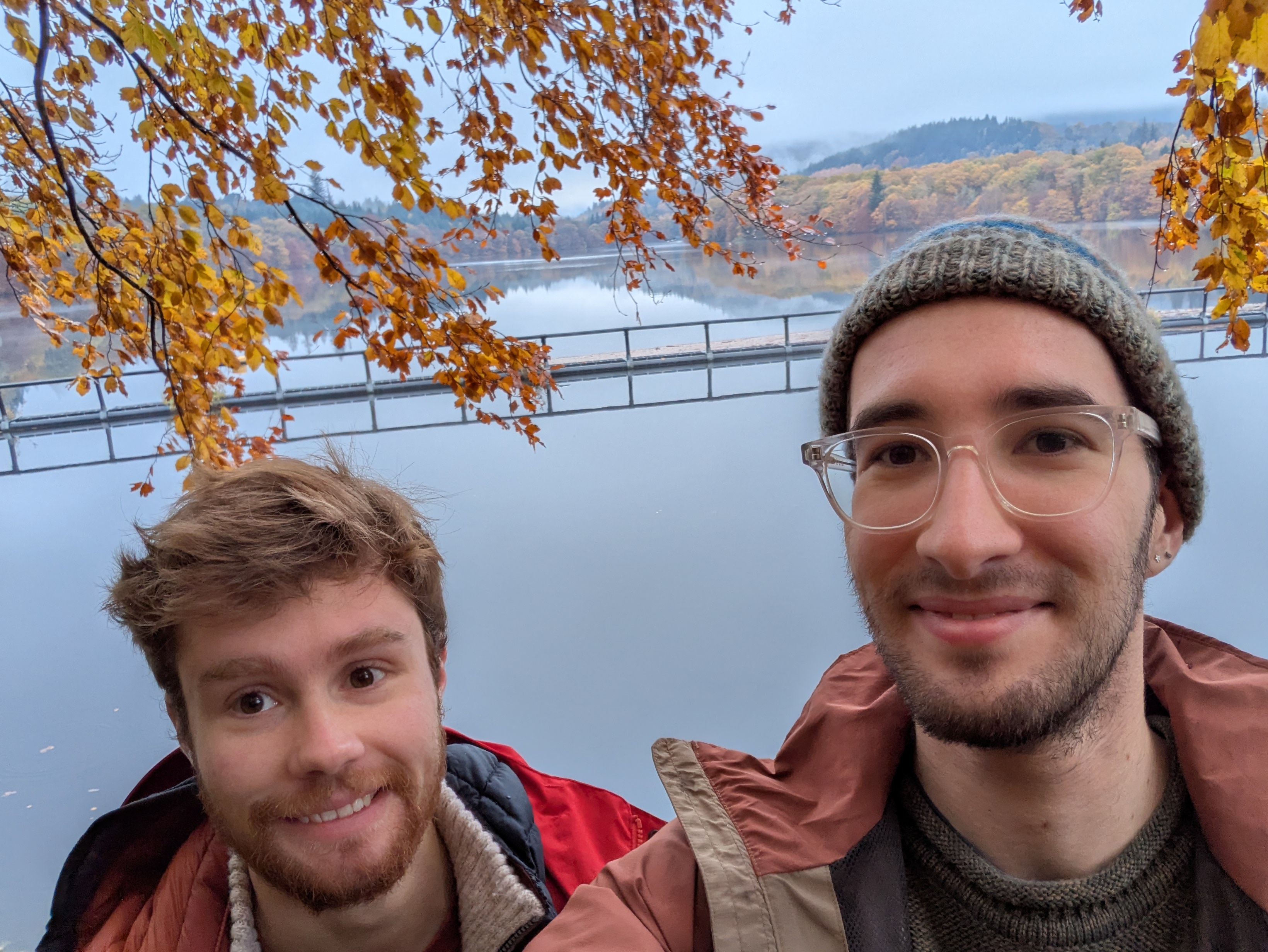 Jay and Leo looking happy, in full view in front of a nice loch.